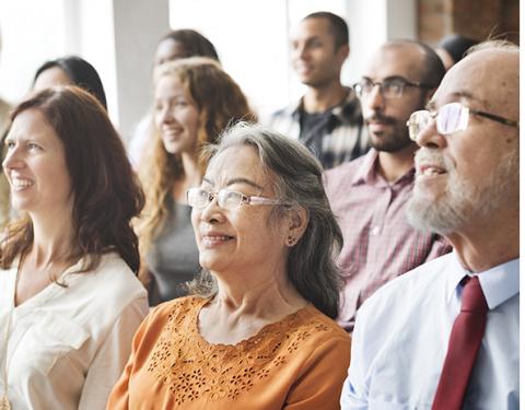 Image of a group of happy people in a meeting setting